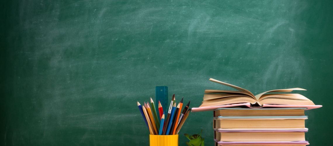 Education and reading concept - group of colorful books on the wooden table